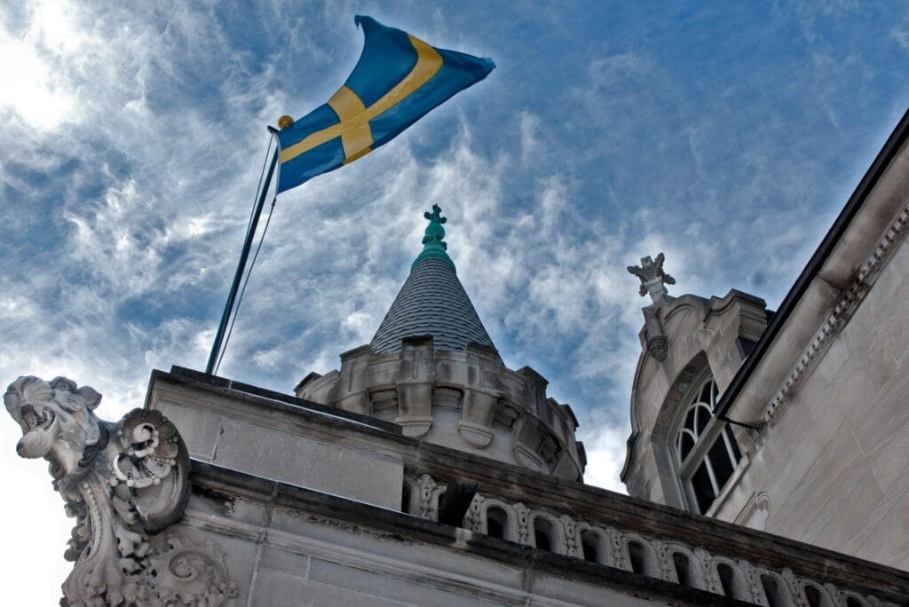Exterior of the American Swedish Institute showing the flag of Sweden